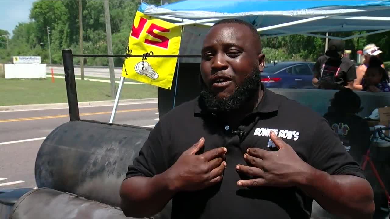 Ronnie Thomas speaking in front of his smoker during a Tampa Bay 28 news feature